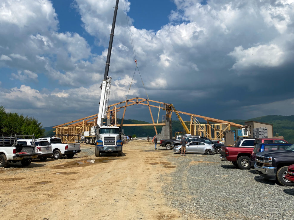 Crane setting the clubhouse timber frames in Echota's construction project.