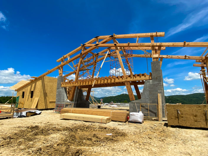 A stunning Clubhouse and Amenity Center is under construction with trusses and Timber Frame by Harmony Timberworks.